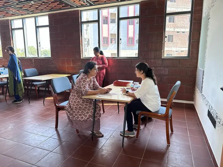 Megha going through a client's reports at the clinic