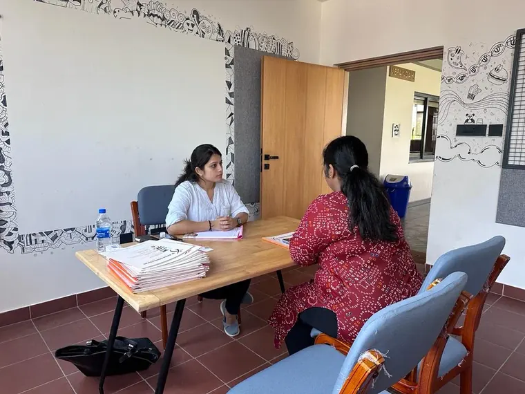 Megha going through a client's blood reports at the clinic